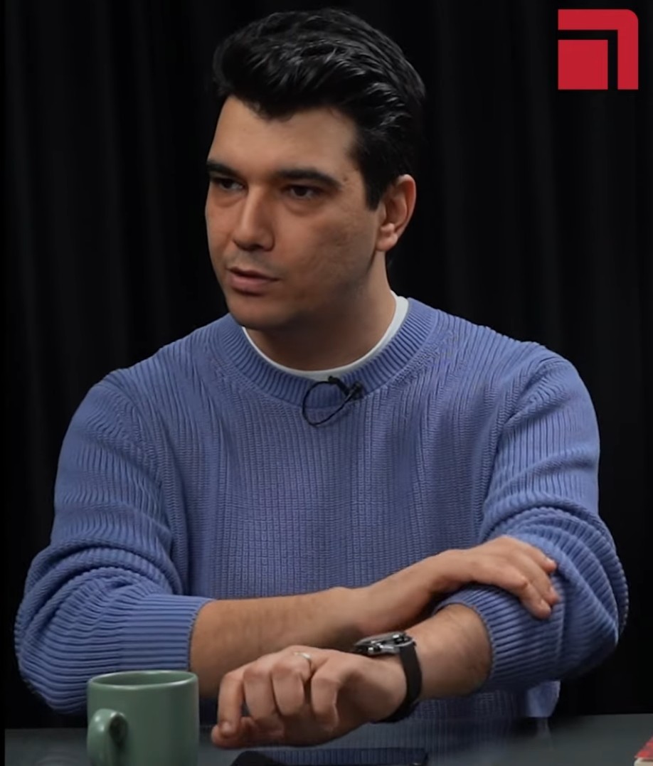 What impression do this handsome man's gaze and stance give?