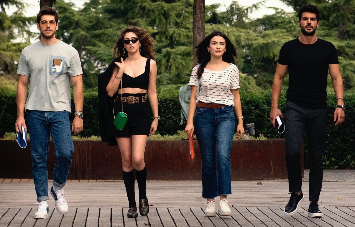 If the group in the photo were stranded on a deserted island, which of the men would dominate and crush the other man and become the owner of the women?